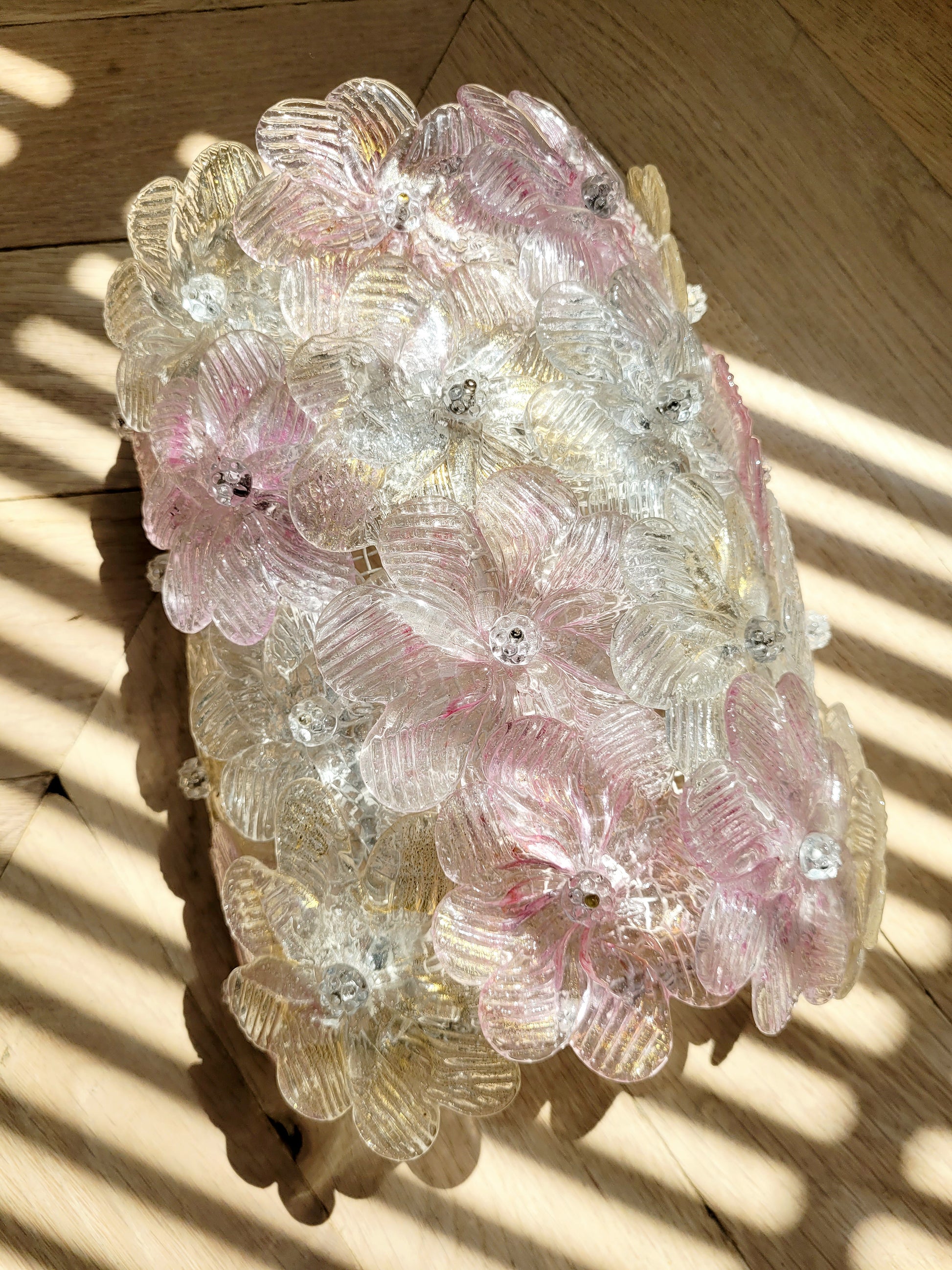 top view of a vintage Murano glass flower wall light with pink, clear and golden petals