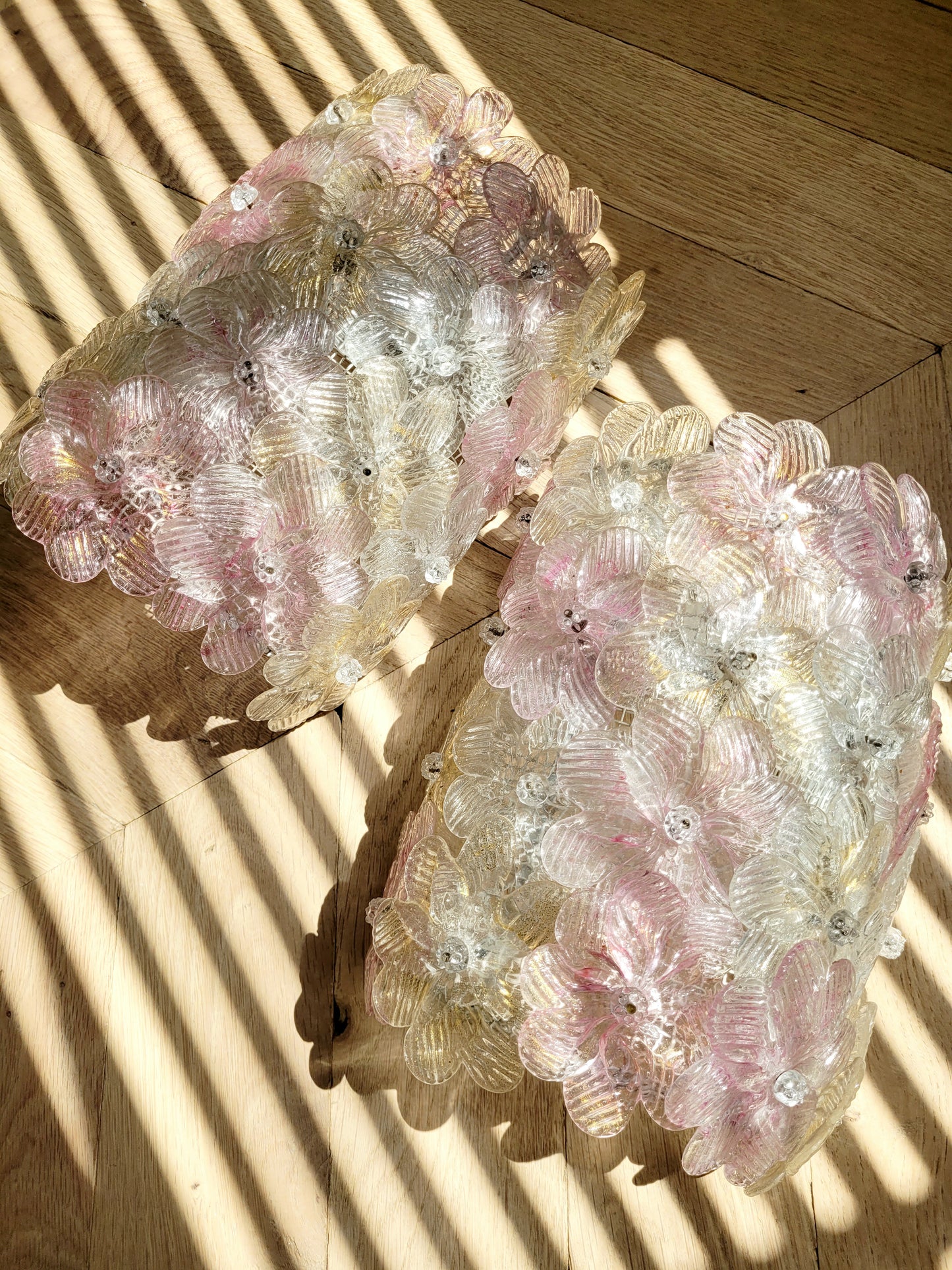 full view of a pair of vintage Murano glass flower wall lights with pink, clear and golden petals