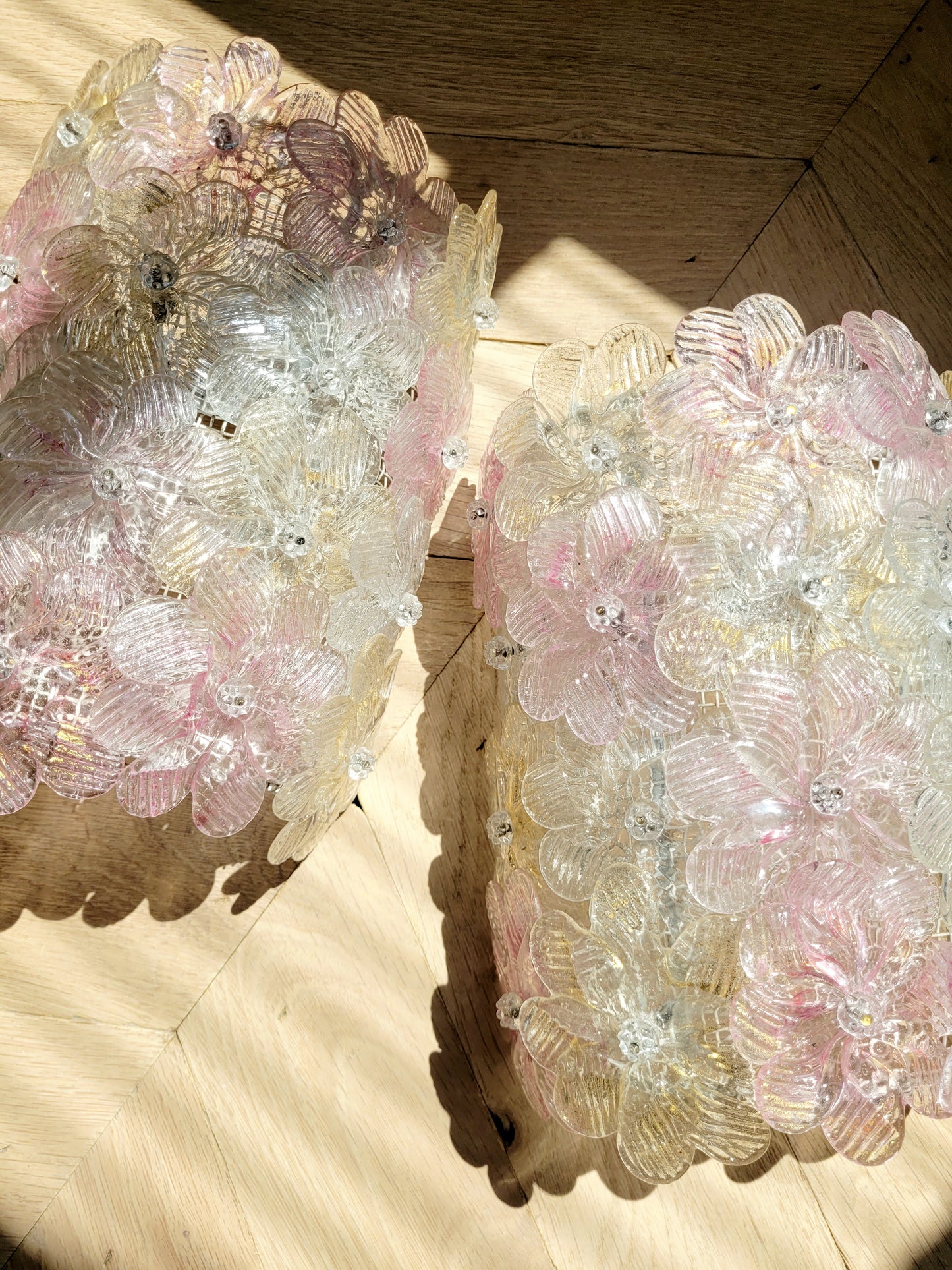 full view of a pair of vintage Murano glass flower wall lights with pink, clear and golden petals