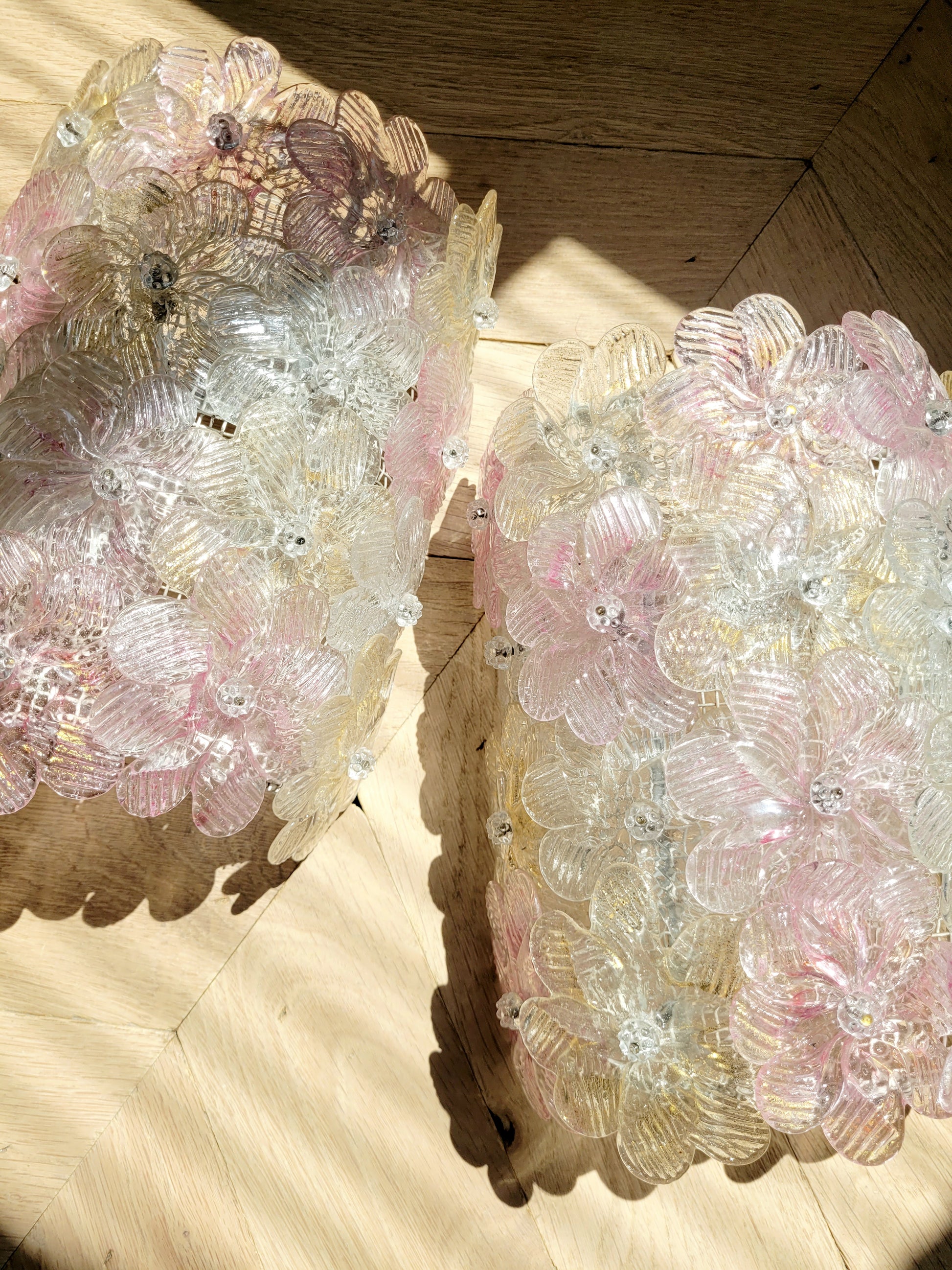 full view of a pair of vintage Murano glass flower wall lights with pink, clear and golden petals