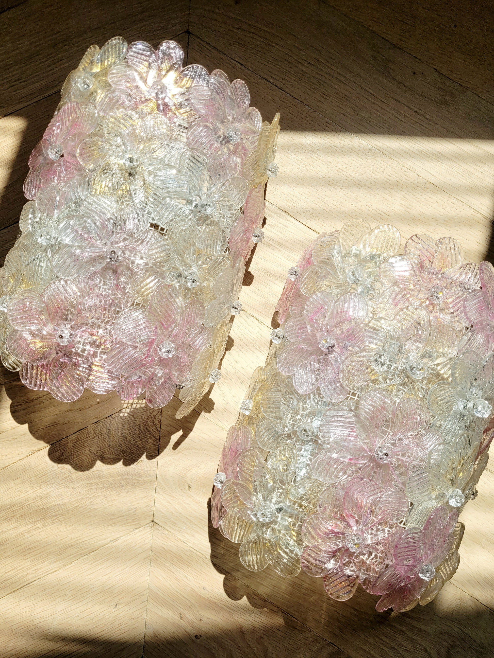 top view of a pair of vintage Murano glass flower wall lights with pink, clear and golden petals