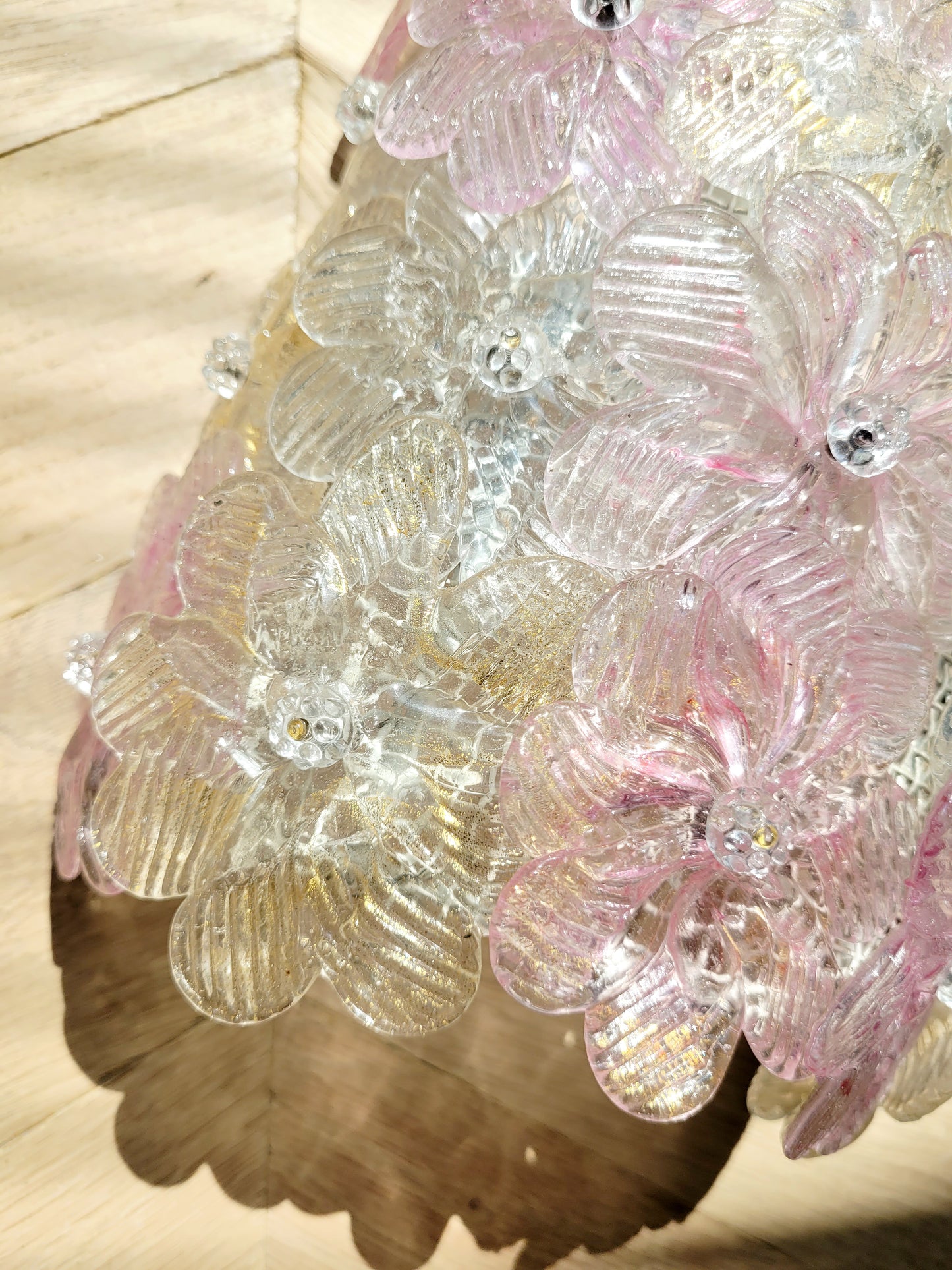 detail of a vintage Murano glass flower wall light with pink, clear and golden petals