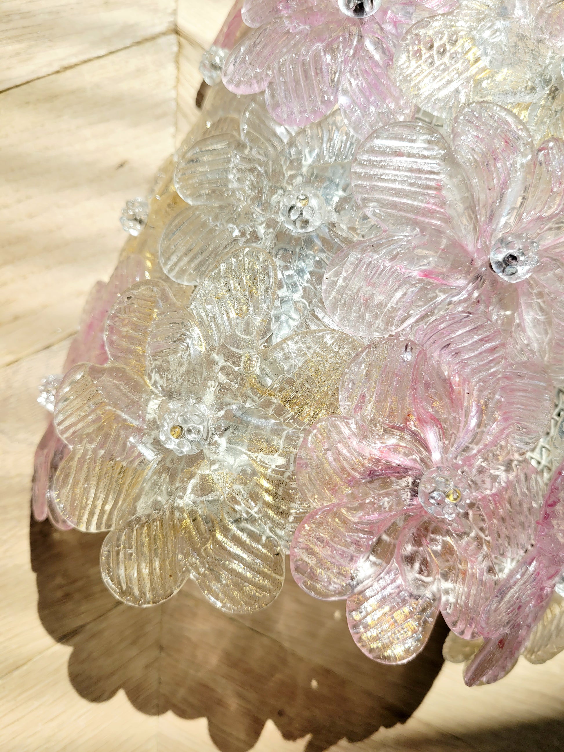 detail of a vintage Murano glass flower wall light with pink, clear and golden petals