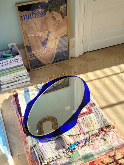 curved wall mirror with rich blue tone