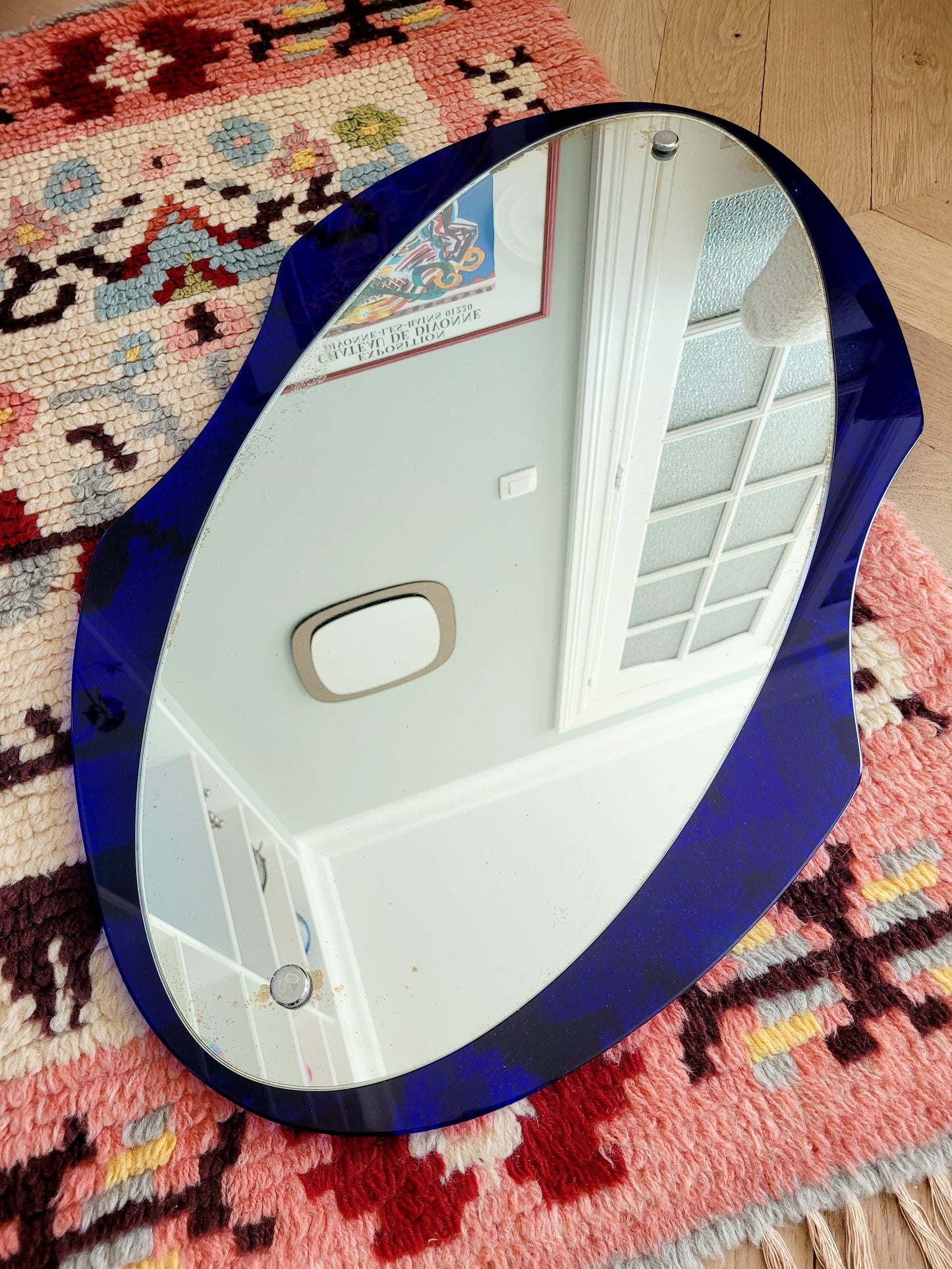 curved wall mirror with rich blue tone