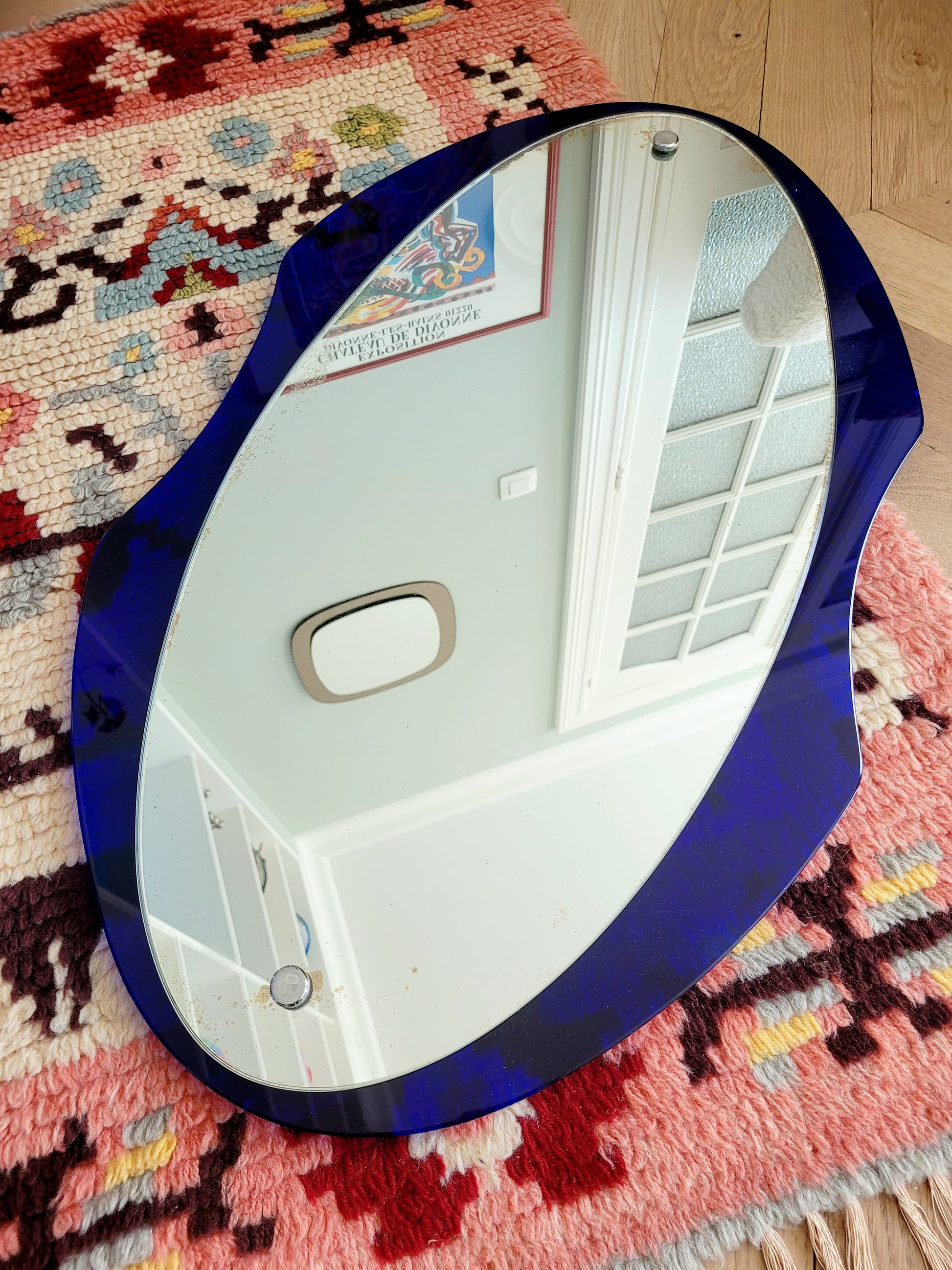 curved wall mirror with rich blue tone