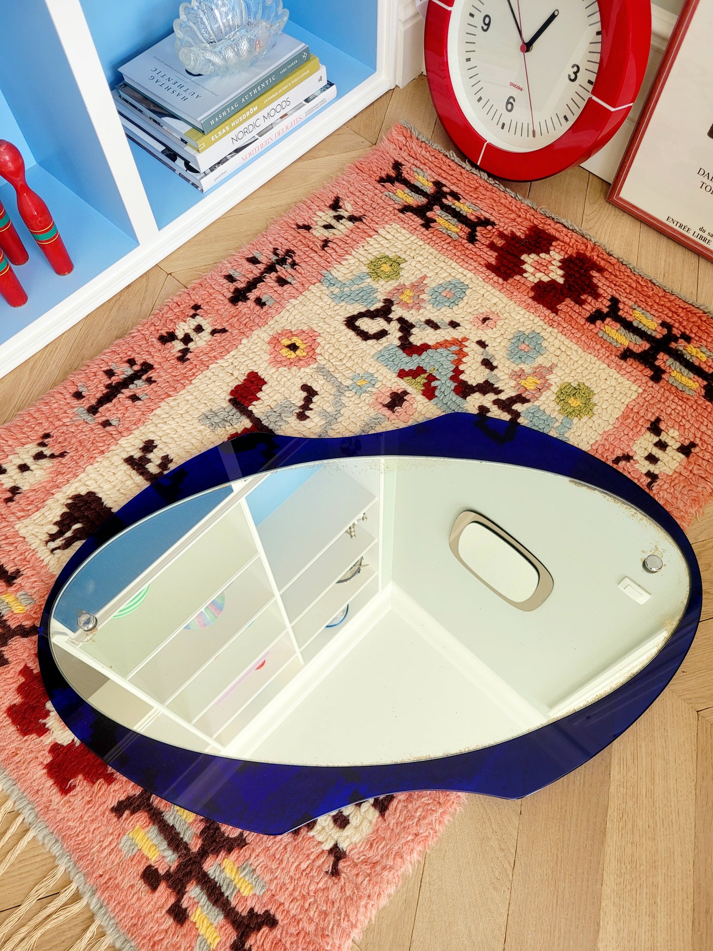 curved wall mirror with rich blue tone