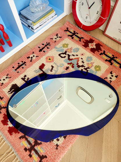 curved wall mirror with rich blue tone