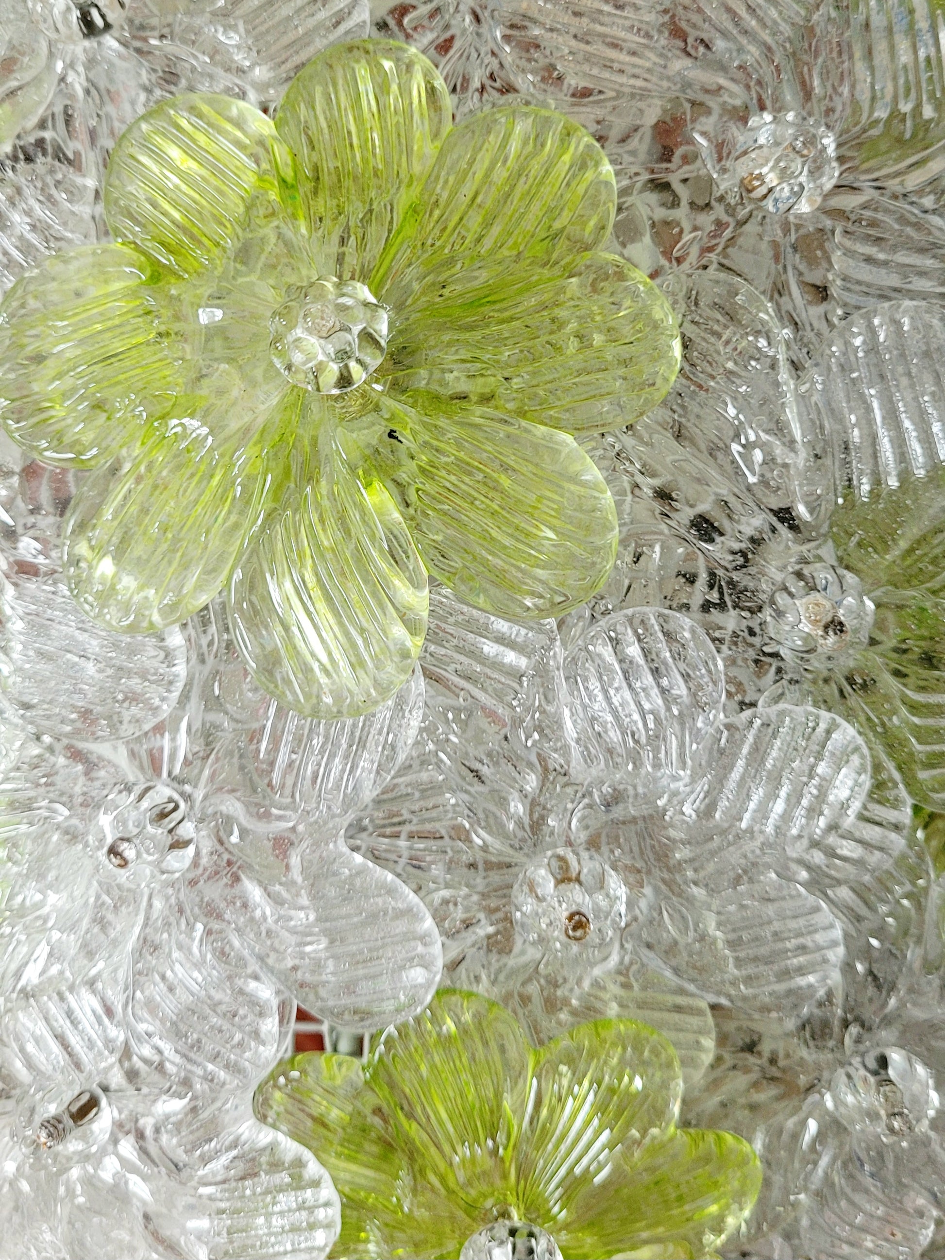 top view of a vintage Murano flower ceiling lamp with clear and green floral petals