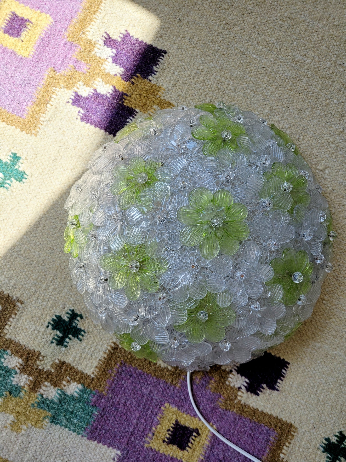top view of a vintage Murano flower ceiling lamp with clear and green floral petals