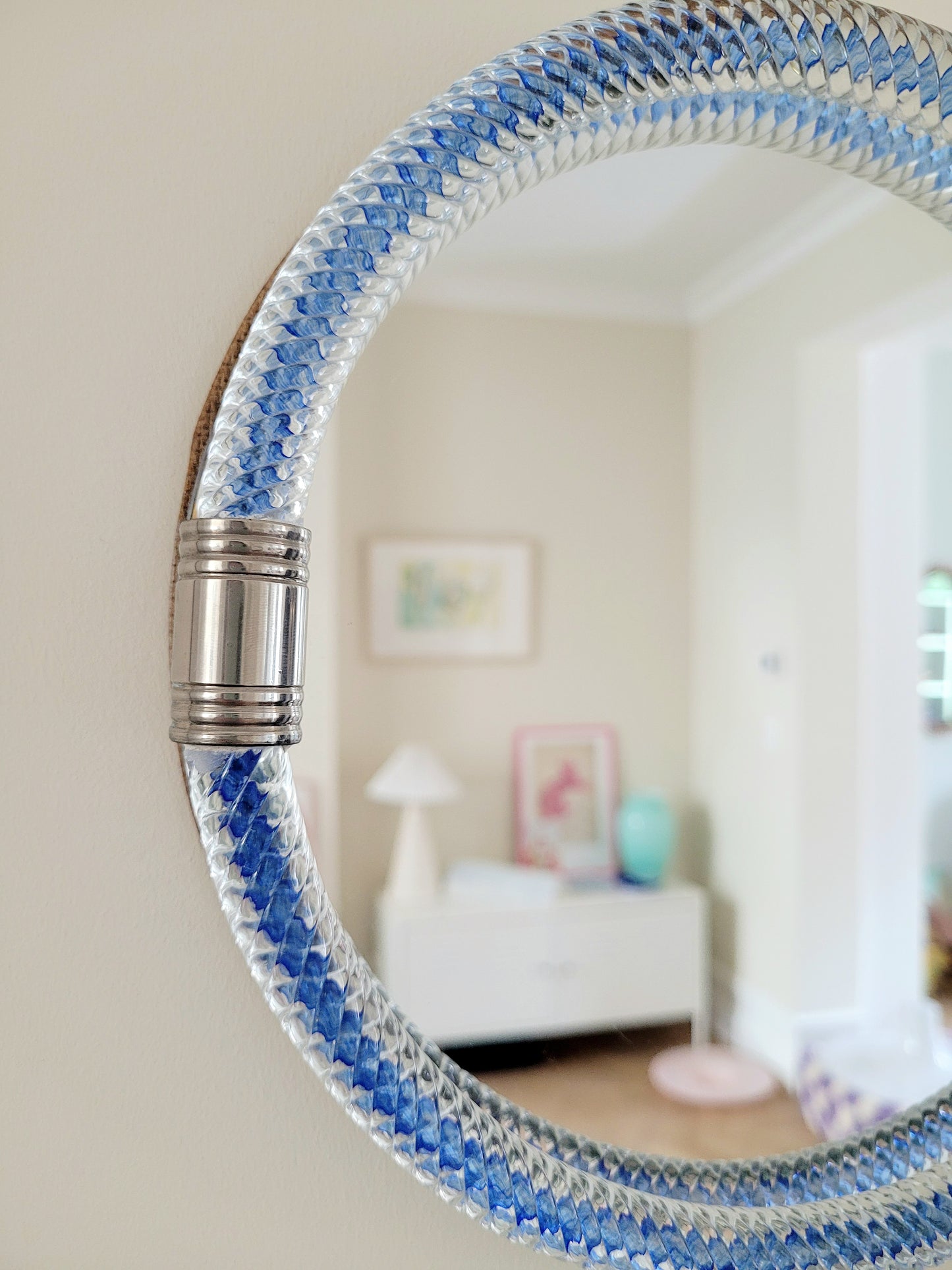 detailed view of a vintage Italian mirror with a twisted frame of vibrant blue Murano glass