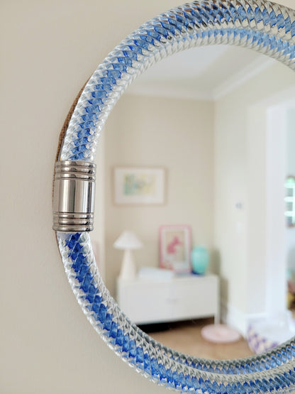 detailed view of a vintage Italian mirror with a twisted frame of vibrant blue Murano glass