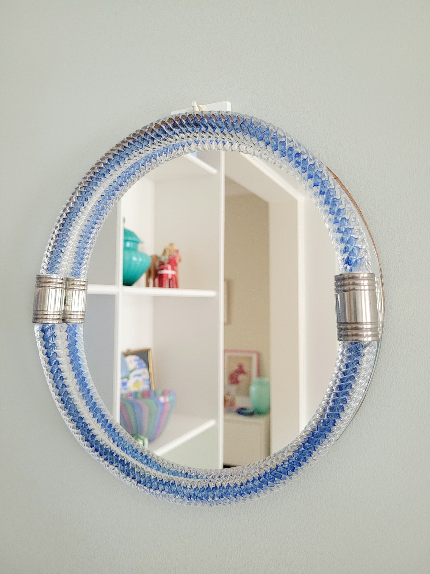 full front view of a vintage Italian mirror with a twisted frame of vibrant blue Murano glass