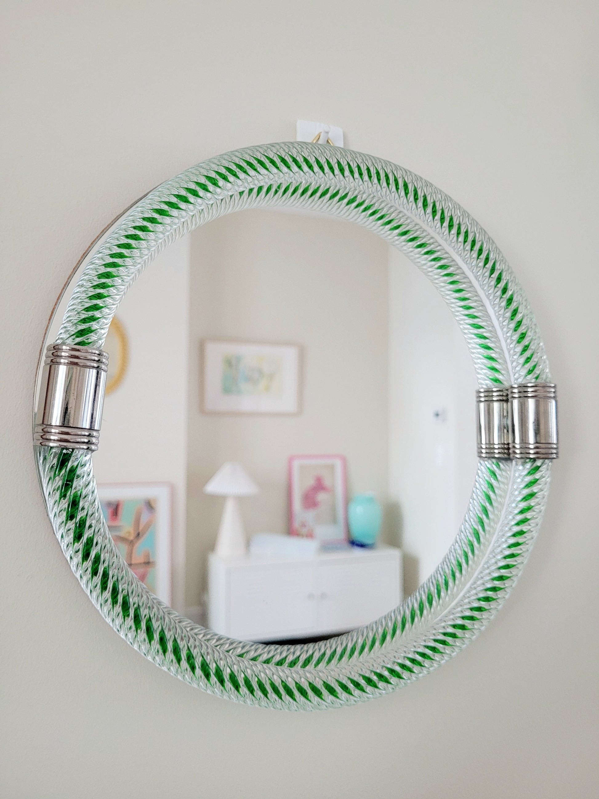 full front view of an Italian round mirror with a twisted green glass frame