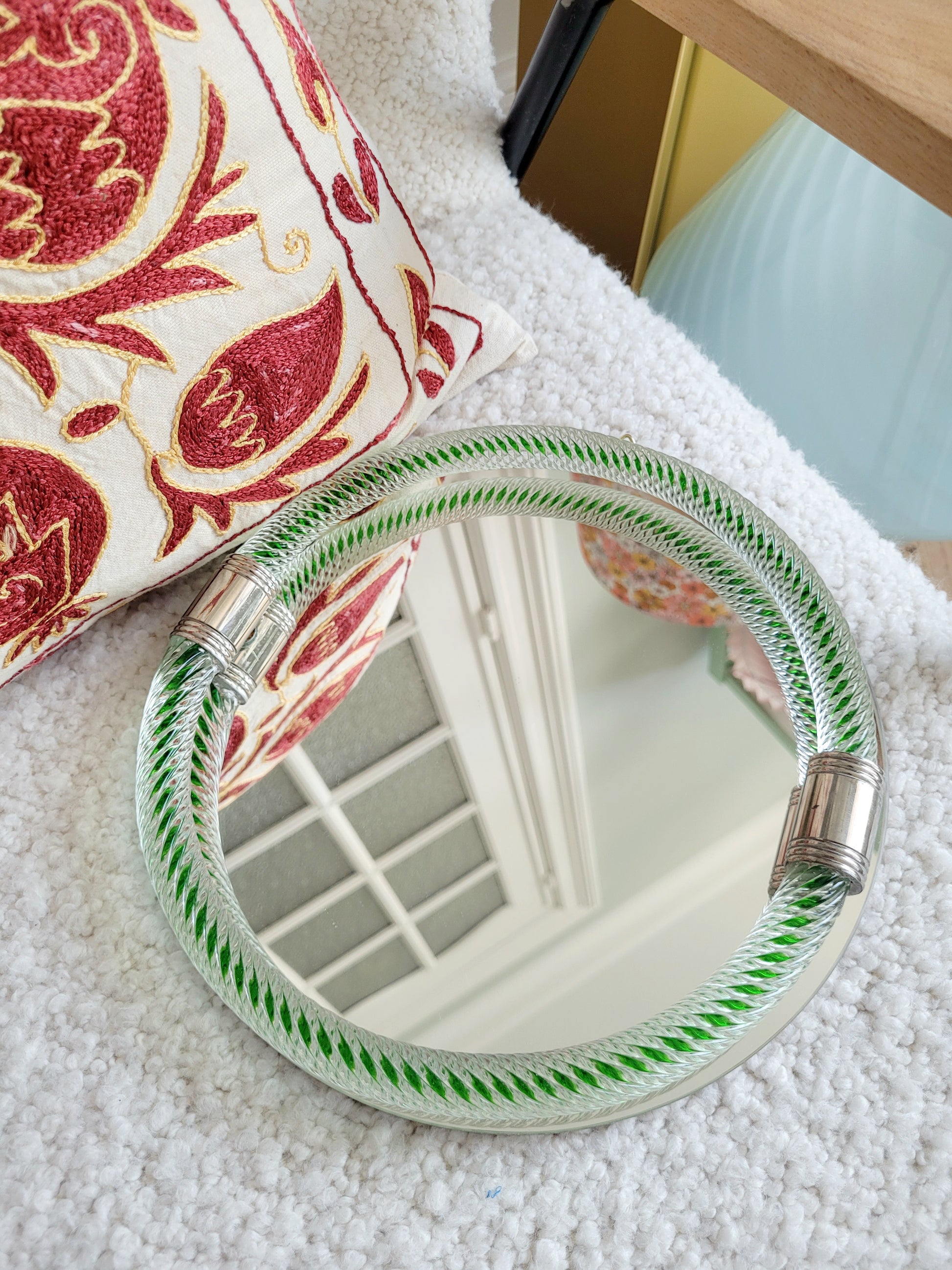 top view of an Italian round mirror with a twisted green glass frame