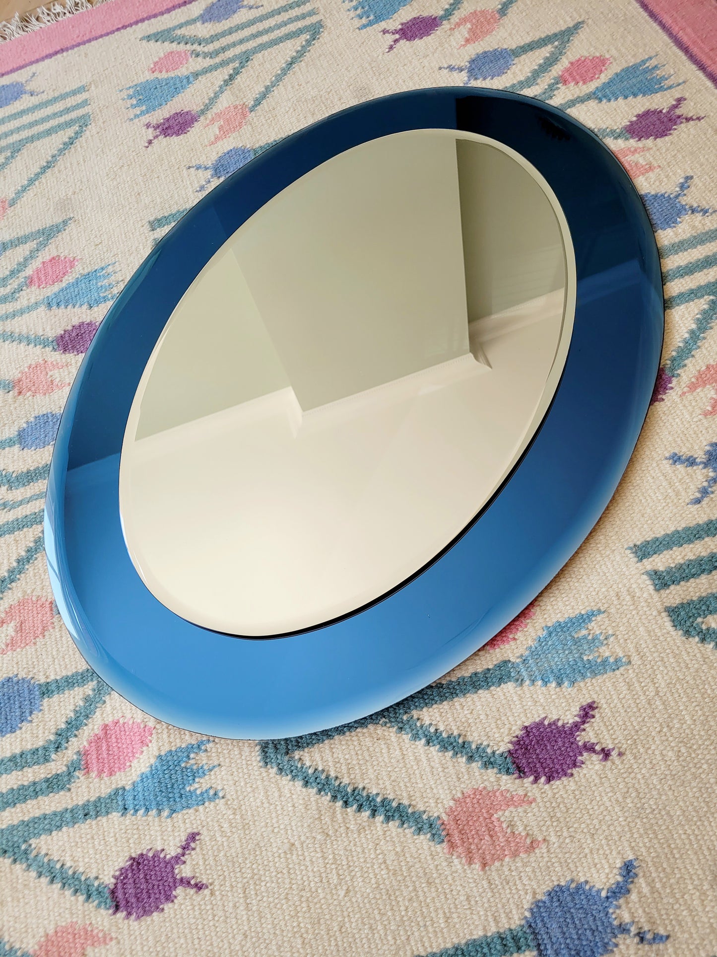 Italian mirror featuring a distinctive light blue frame