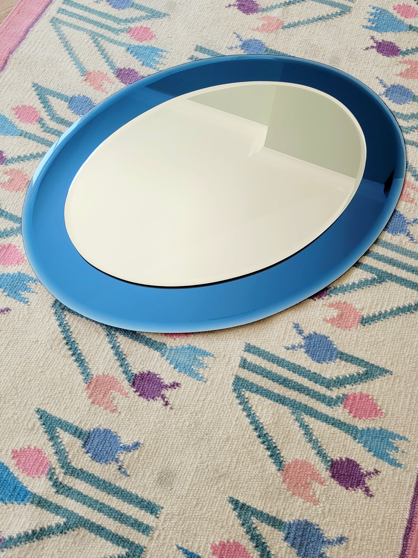 Italian mirror featuring a distinctive light blue frame