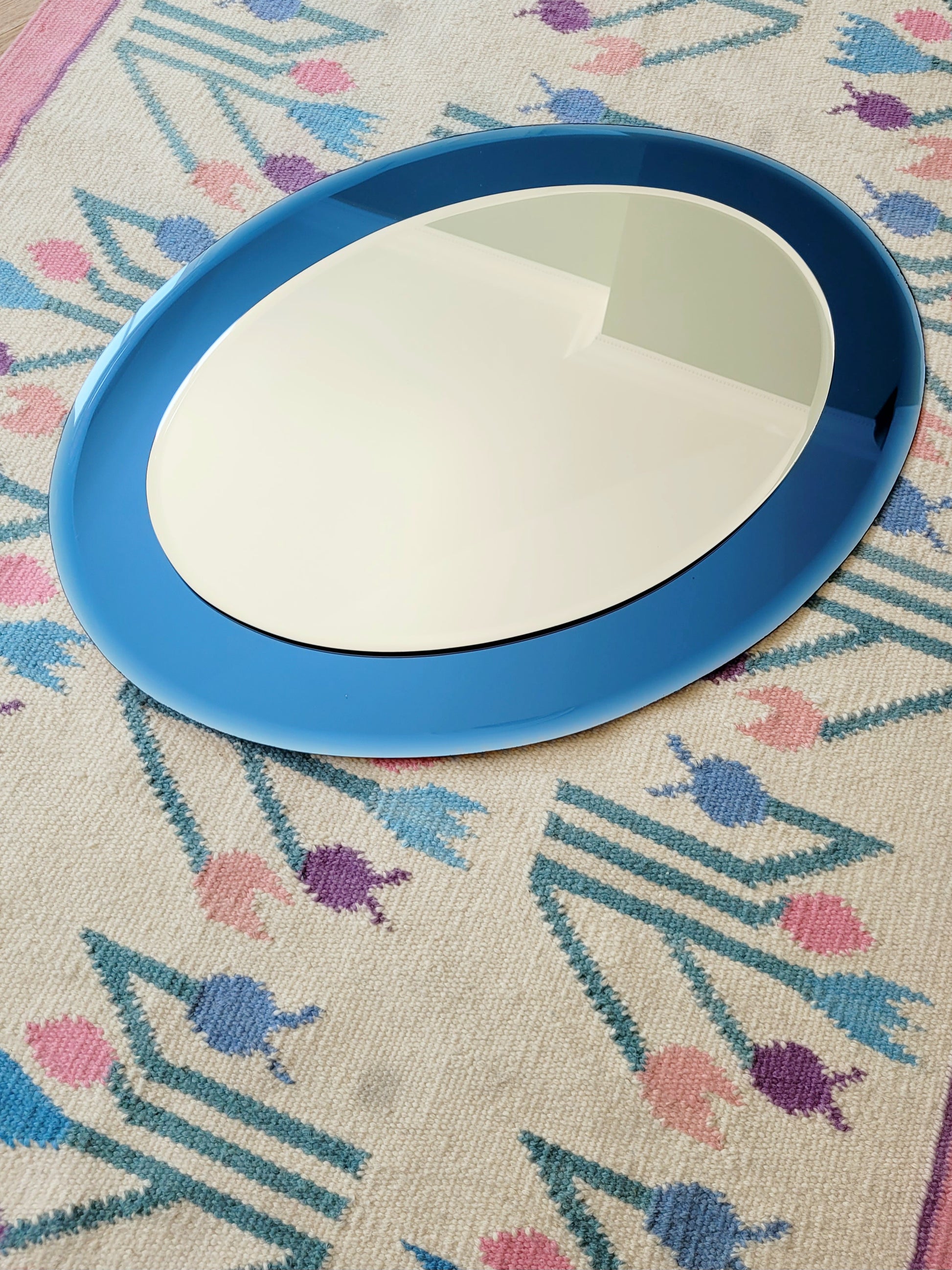 Italian mirror featuring a distinctive light blue frame