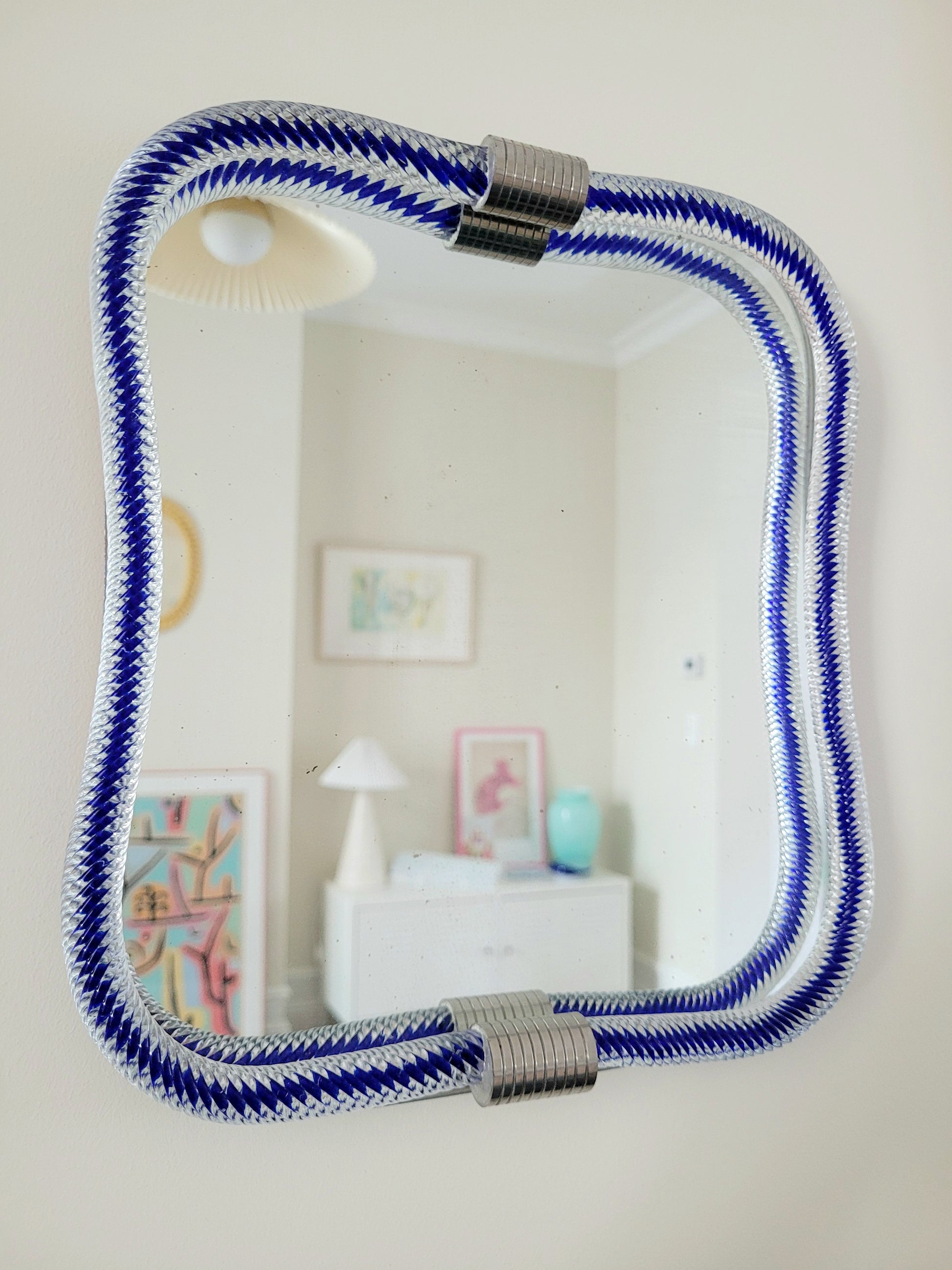 full view of a vintage Italian mirror, accentuated by a twisted frame of clear/blue Murano glass