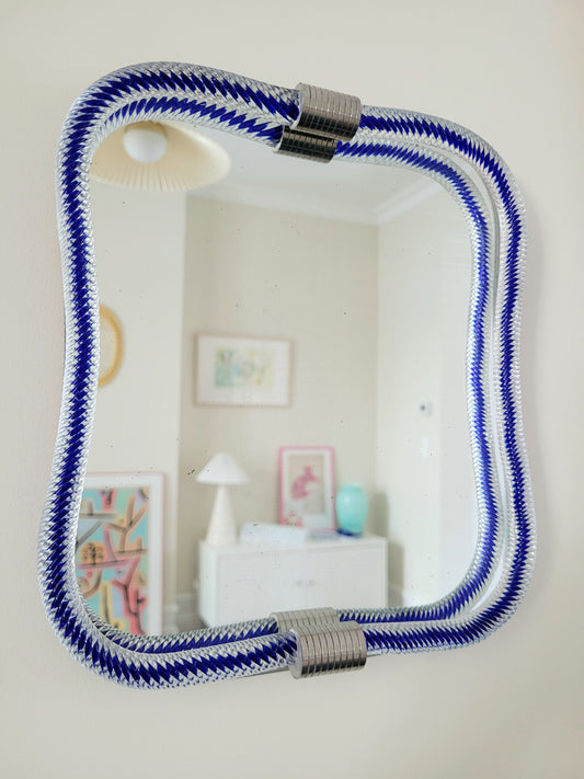 full view of a vintage Italian mirror, accentuated by a twisted frame of clear/blue Murano glass