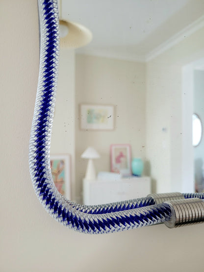 detail of a vintage Italian mirror, accentuated by a twisted frame of clear/blue Murano glass
