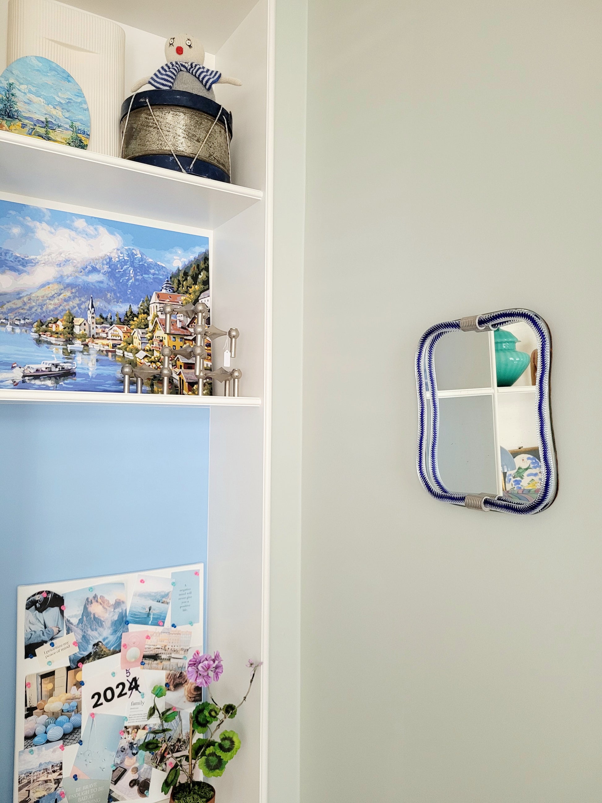 full view of a vintage Italian mirror, accentuated by a twisted frame of clear/blue Murano glass