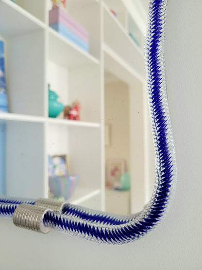 detail of a vintage Italian mirror, accentuated by a twisted frame of clear/blue Murano glass