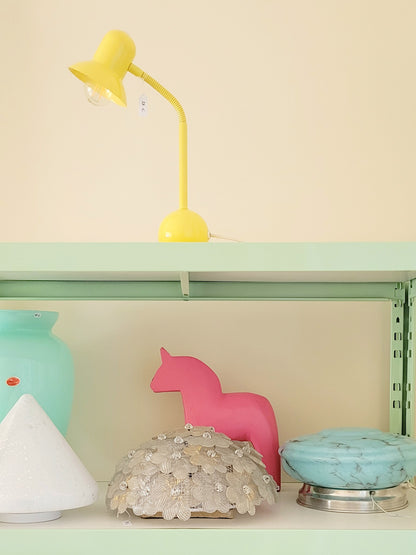 full view of a large pink wooden Dala horse on a shelf with other vintage items