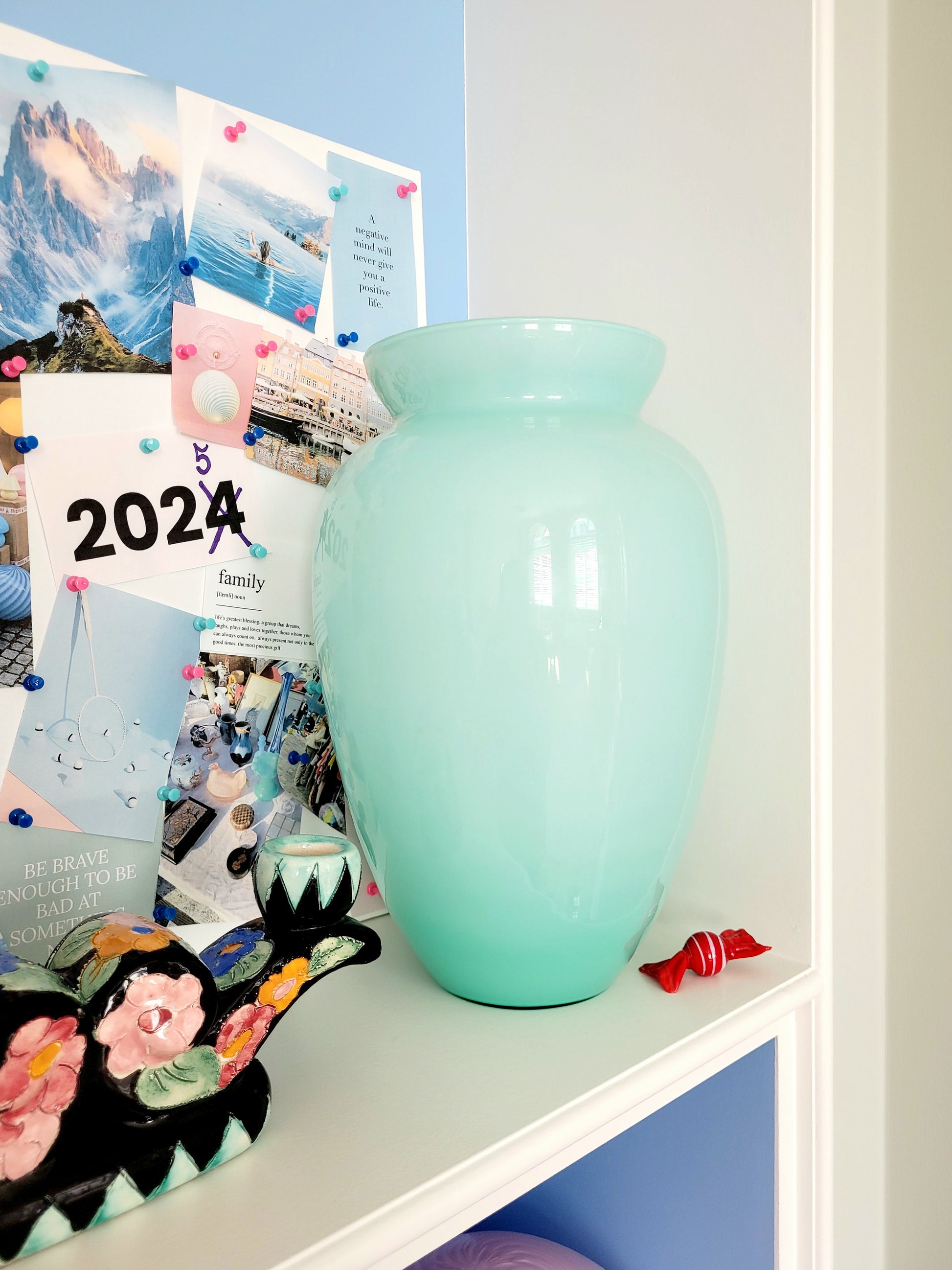 full view of a vintage Murano vase with a glossy aquamarine-mint green exterior over a soft milk-white opaline interior