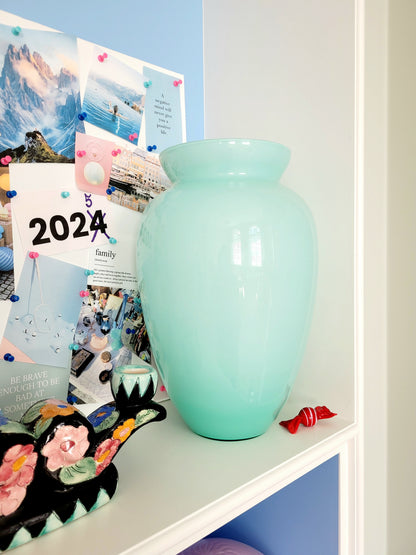 full view of a vintage Murano vase with a glossy aquamarine-mint green exterior over a soft milk-white opaline interior