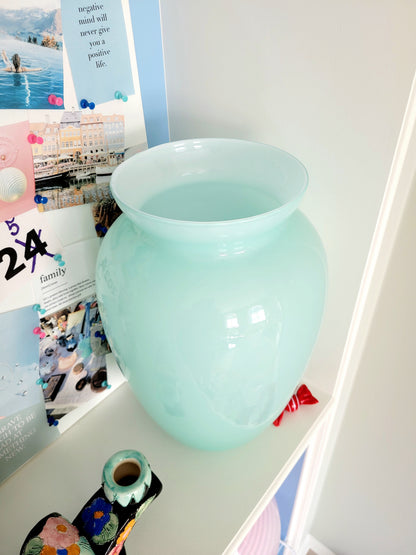 full view of a vintage Murano vase with a glossy aquamarine-mint green exterior over a soft milk-white opaline interior