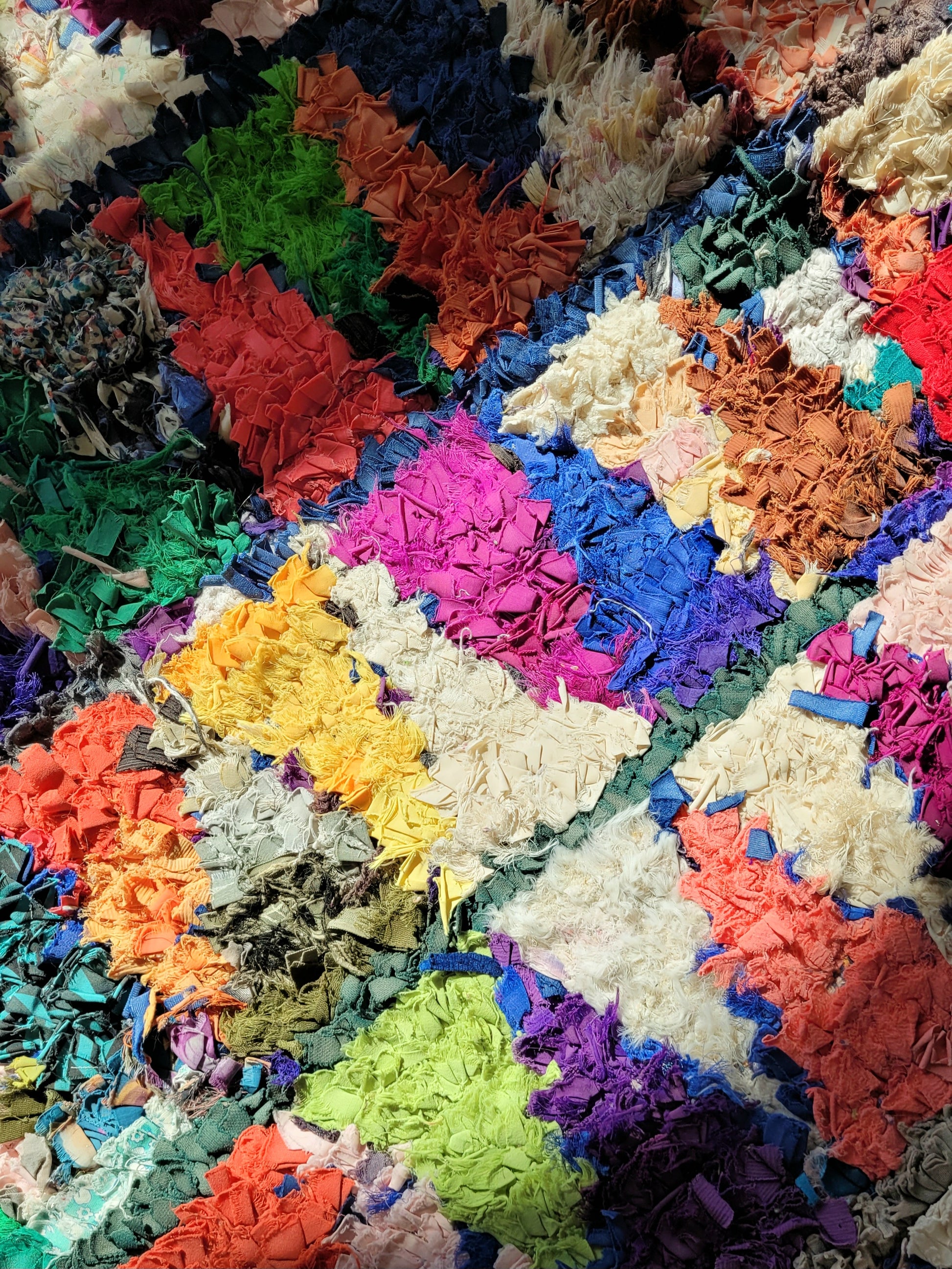 detailed view of a handwoven Boucherouite rug featuring vibrant colours