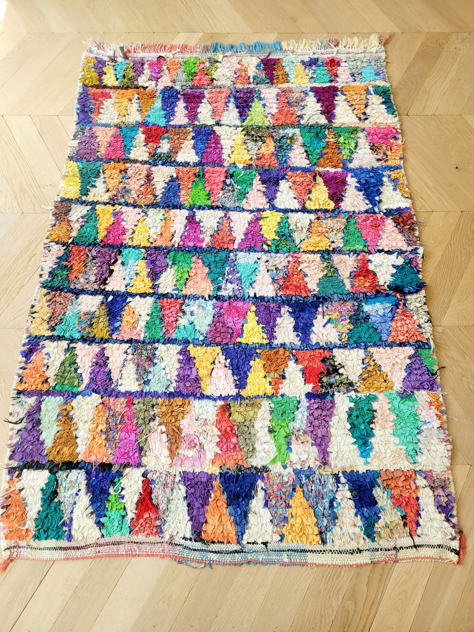 top view of a handwoven Boucherouite rug featuring vibrant colours