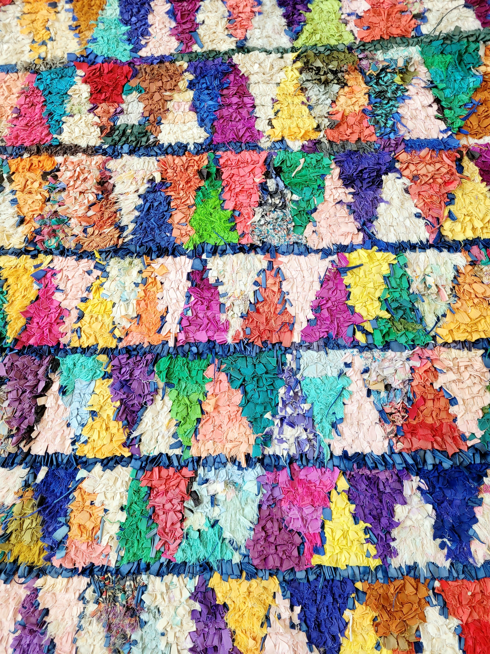top view of a handwoven Boucherouite rug featuring vibrant colours