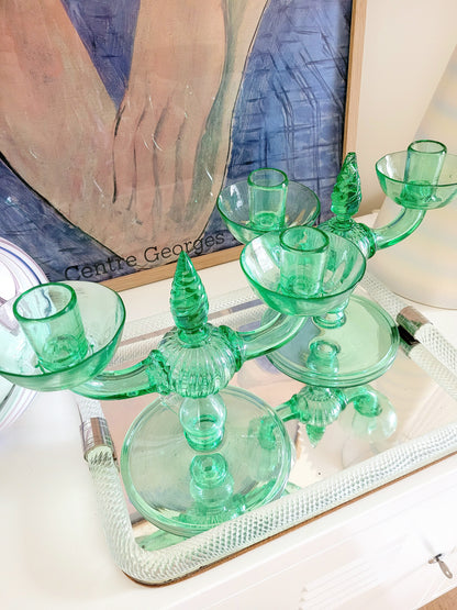 detail of a pair of light green Murano glass candle holders, attributed to Vittorio Zecchin, renowned Italian artist on a vintage Murano mirror tray and with a Murano vase in the back and a framed Matisse poster.