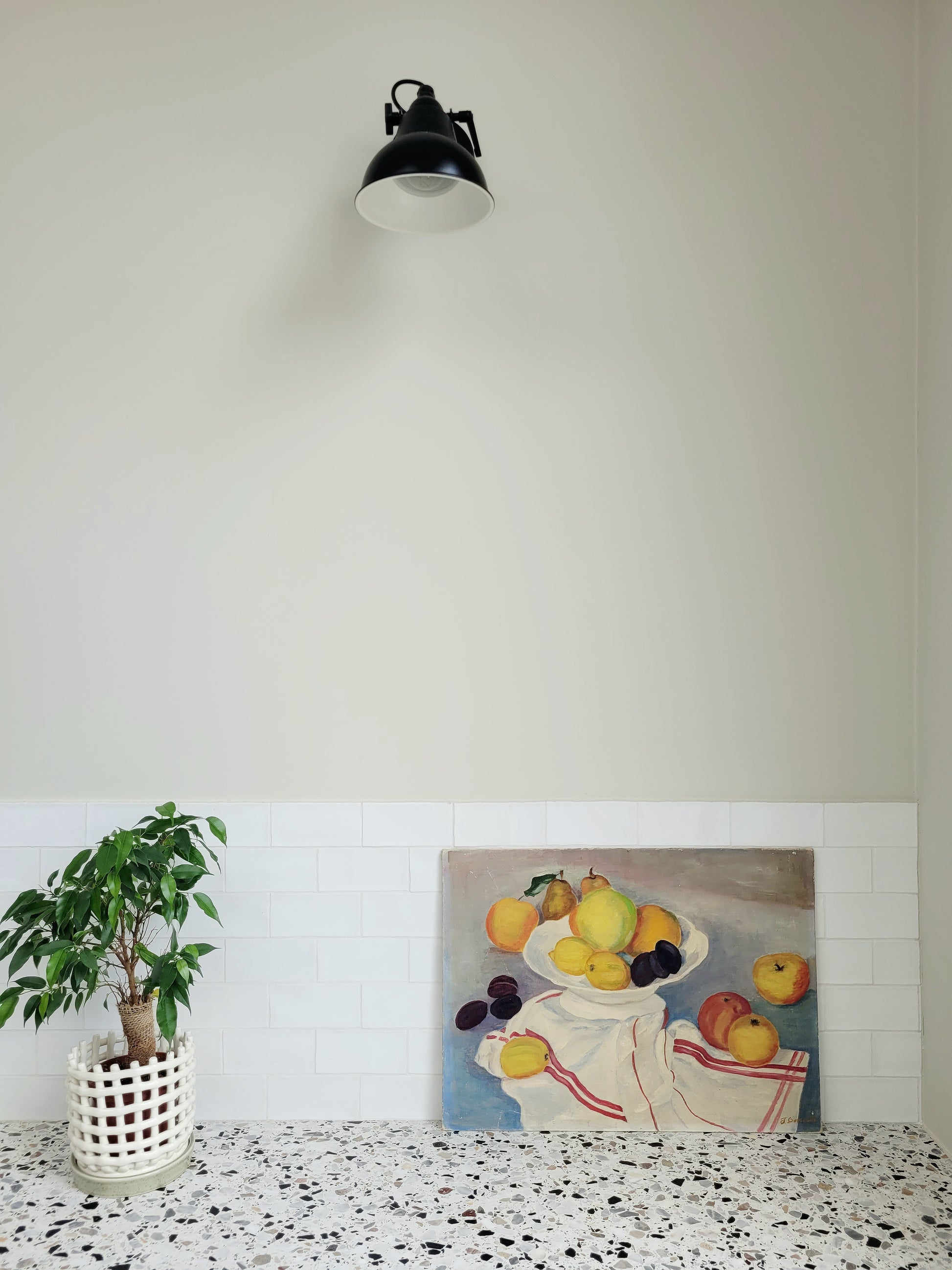 oil painting with still life of a fruit bowl on a  tea towel, placed on a terrazzo kitchen top