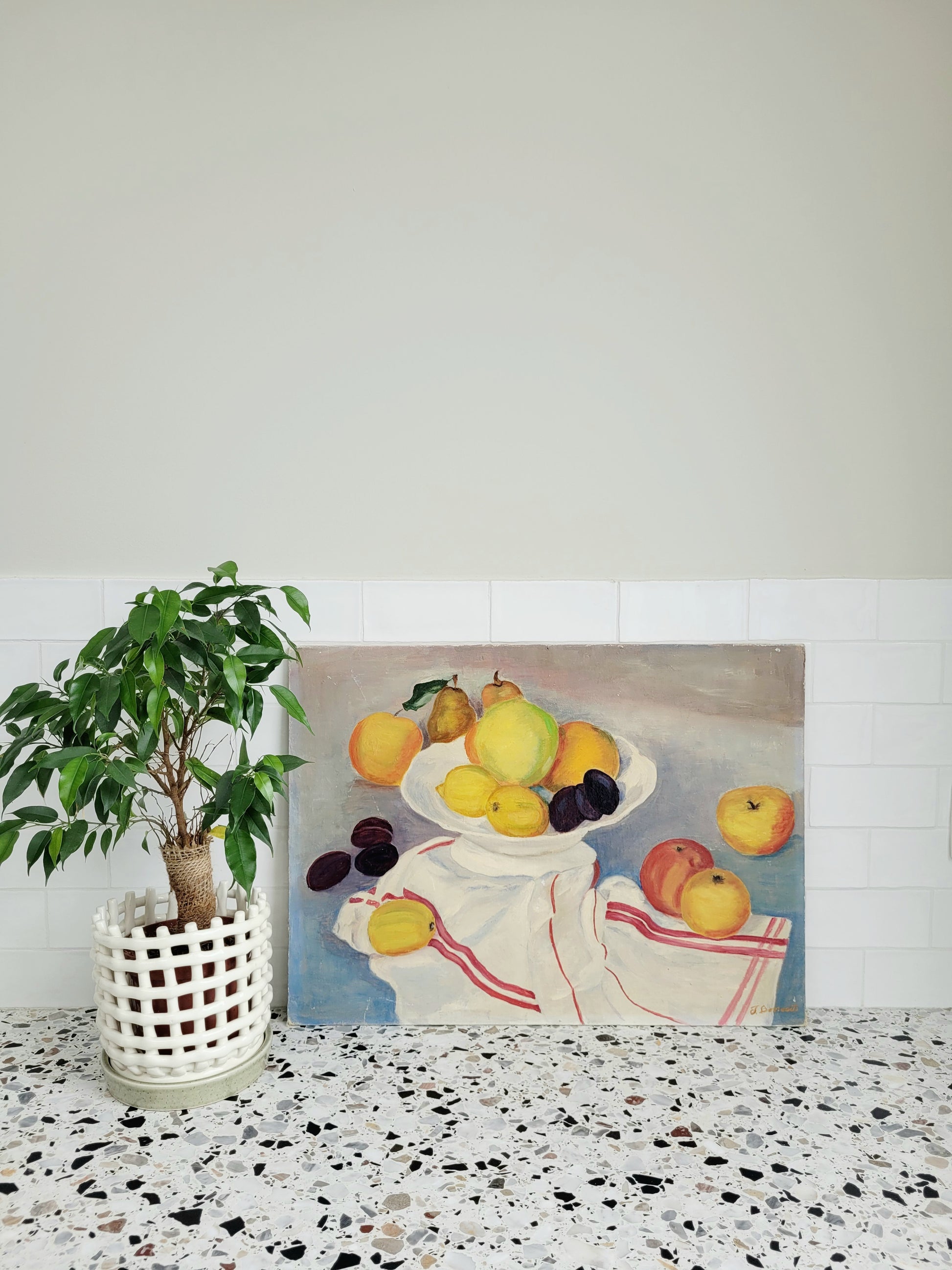 oil painting with still life of a fruit bowl on a  tea towel, placed on a terrazzo kitchen top