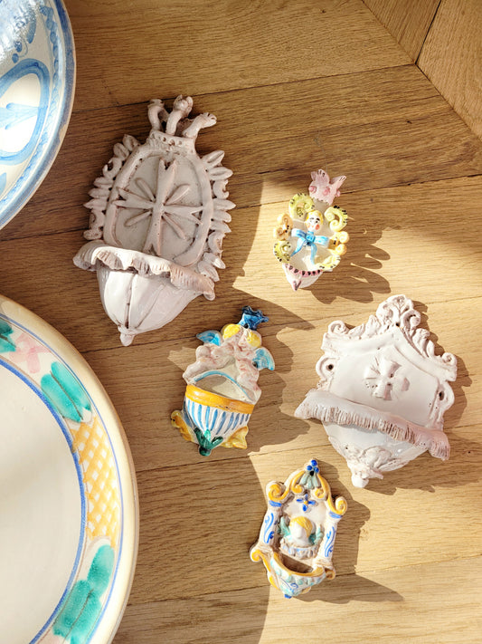top view of a set of five dainty looking Italian "acquasantiere" (holy water fonts)