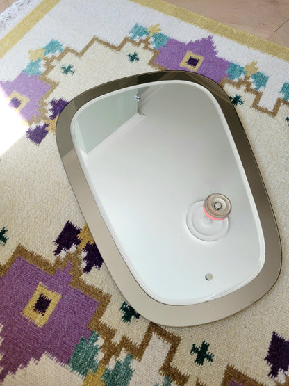  top view of a two-tone Italian mirror featuring smoked glass edging 