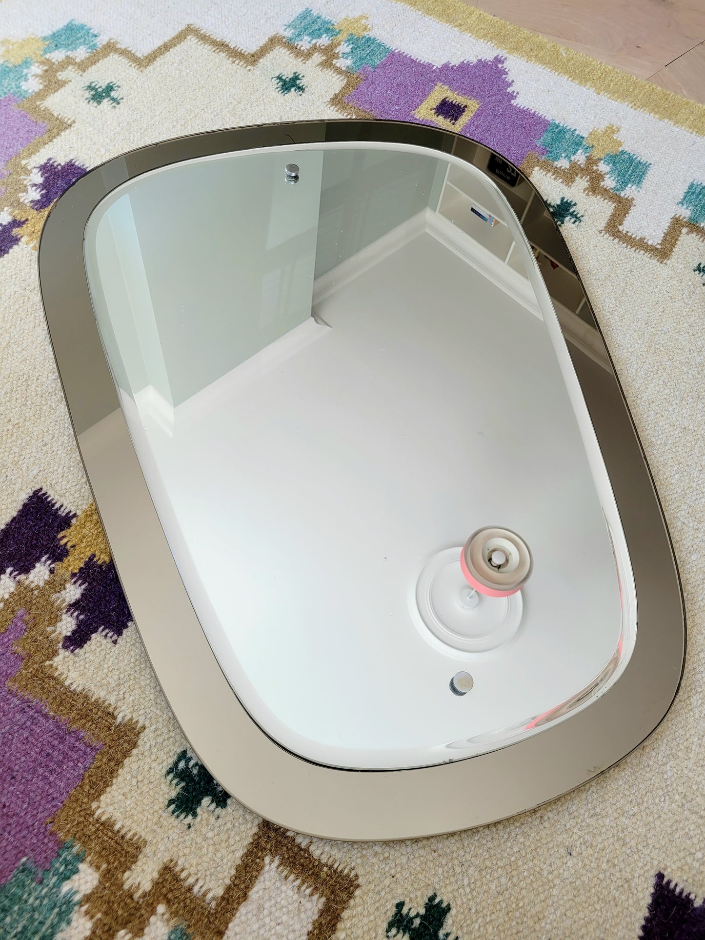  top view of a two-tone Italian mirror featuring smoked glass edging 