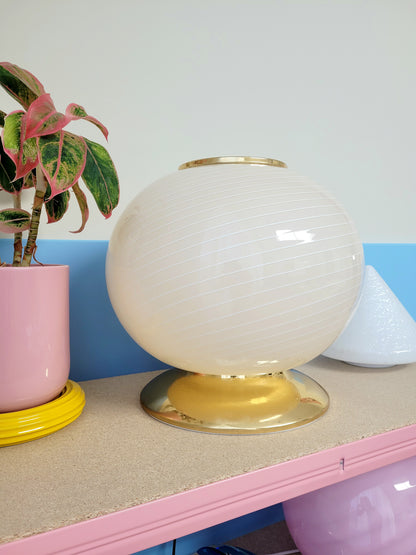 vintage Murano table lamp in a soft light yellow or cream hue with swirl pattern and a brass base