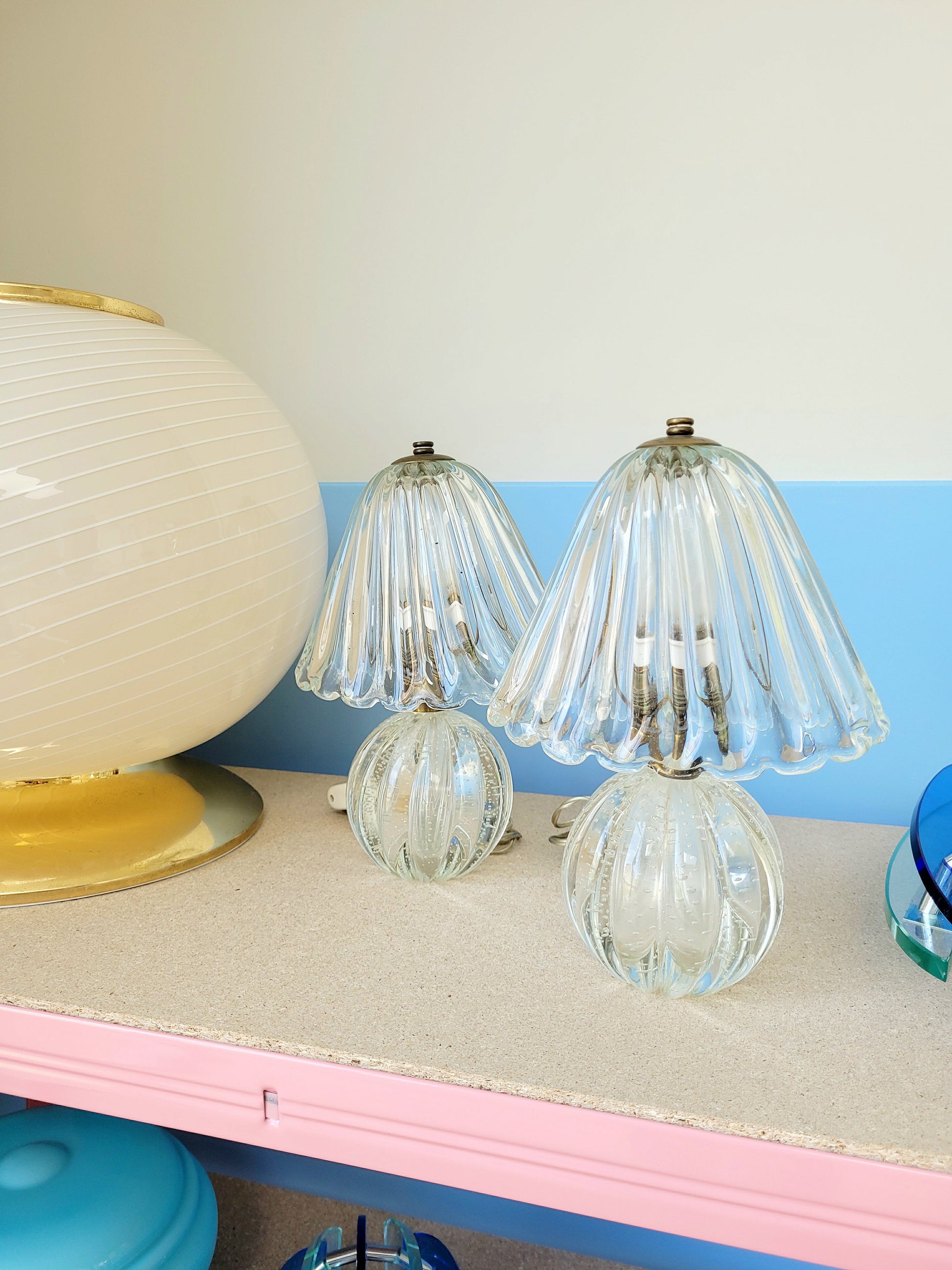 side view of a pair of vintage clear Murano table lamps