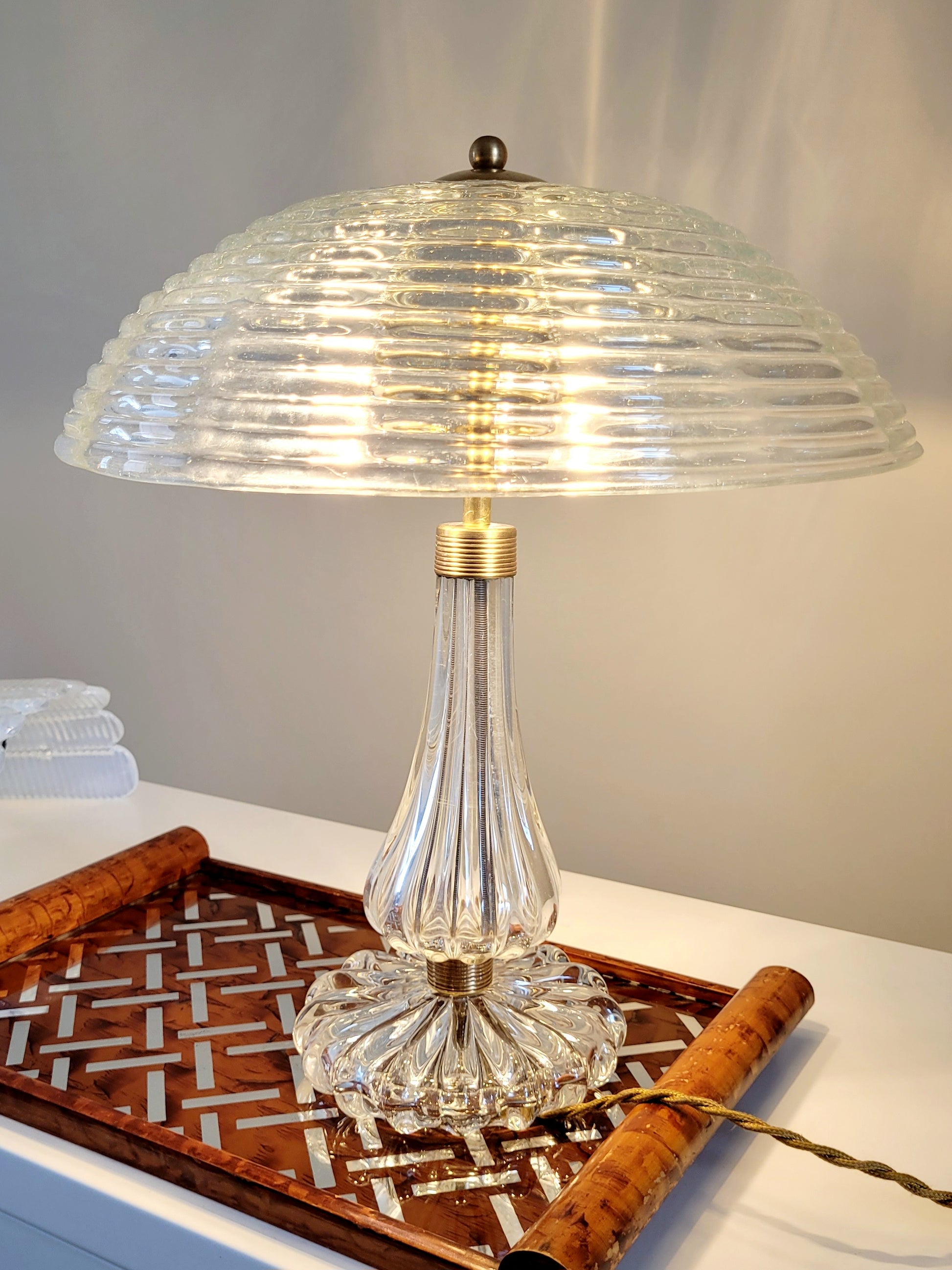 clear Murano glass table lamp feauturing a ribbed shade and brass hardware