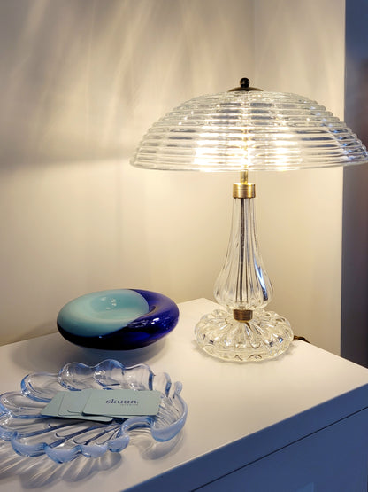 clear Murano glass table lamp feauturing a ribbed shade and brass hardware
