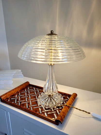 clear Murano glass table lamp feauturing a ribbed shade and brass hardware