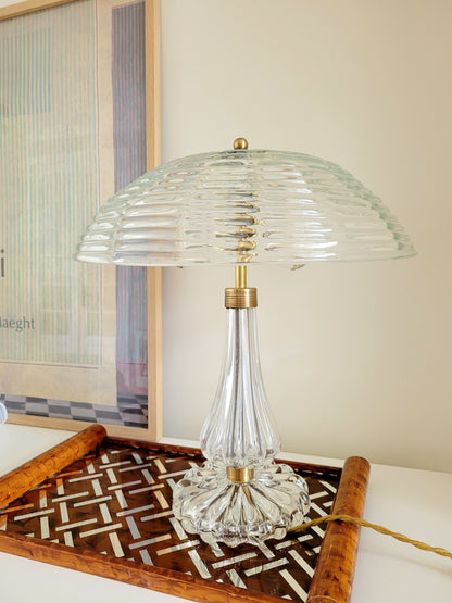 clear Murano glass table lamp feauturing a ribbed shade and brass hardware