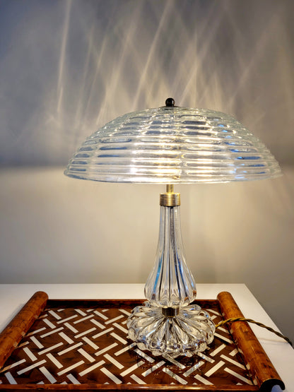 clear Murano glass table lamp feauturing a ribbed shade and brass hardware