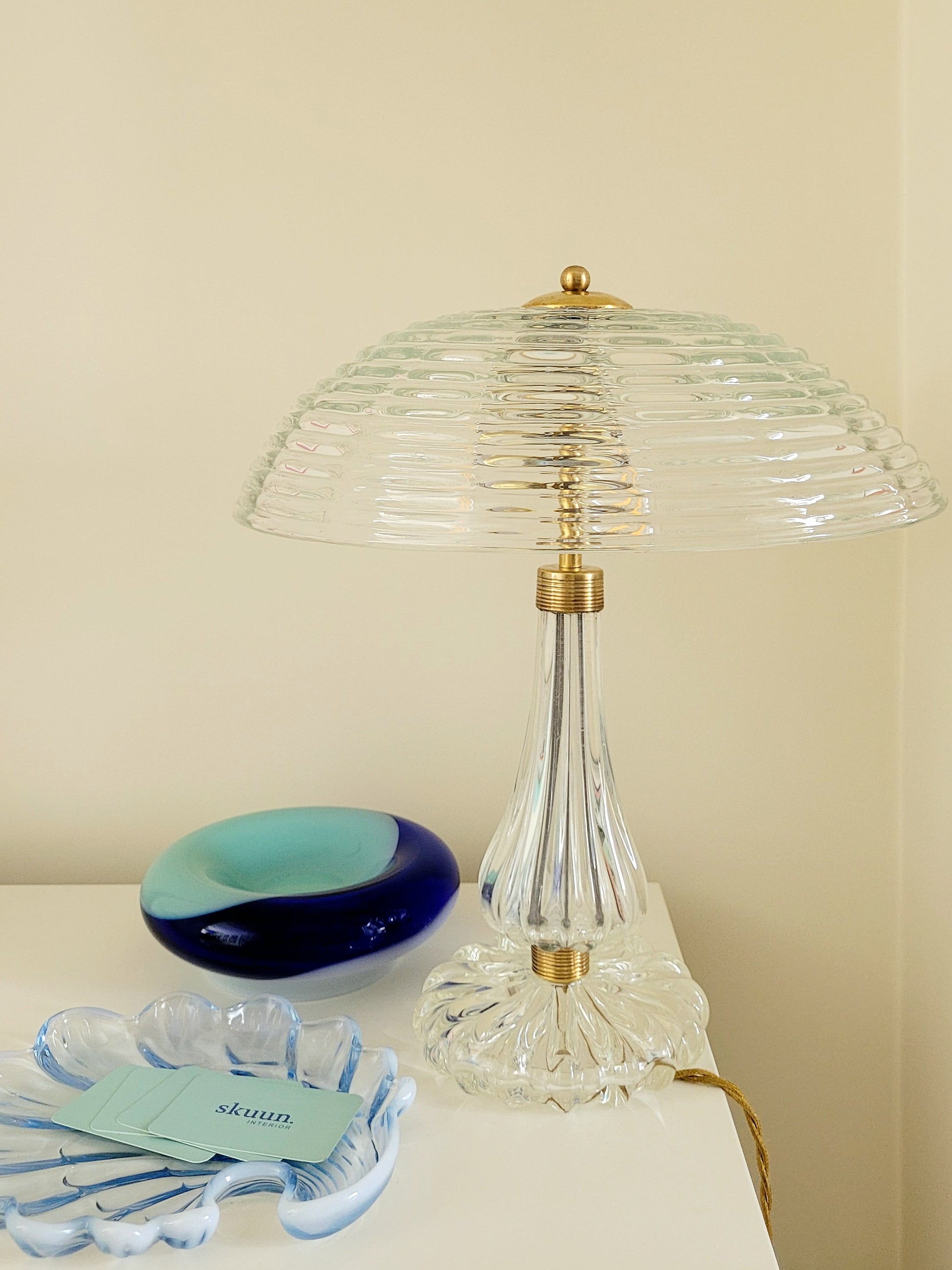 clear Murano glass table lamp feauturing a ribbed shade and brass hardware